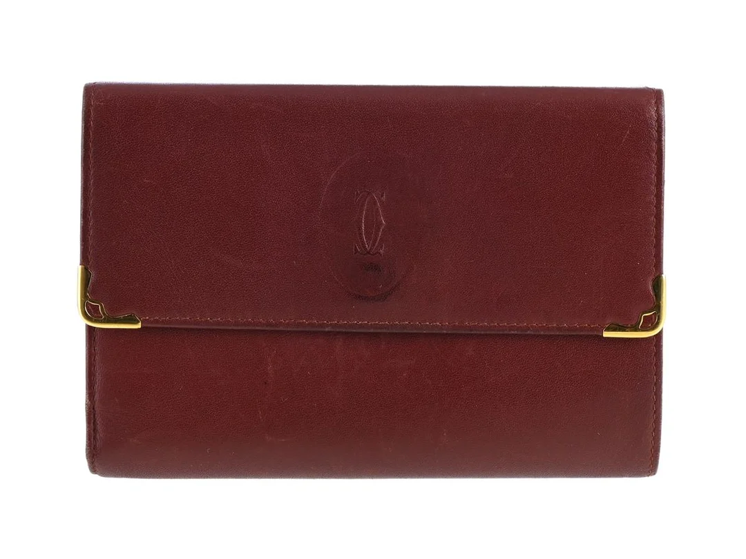 PLÅNBOK, CARTIER, vinrött skinn, guldfärgade beslag, 14,5x10x1 cm, ask. — Accessoarer/Plånböcker — Kaplans