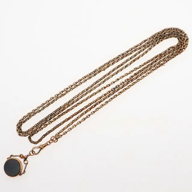 A 9CT GOLD LONG GUARD CHAIN.
