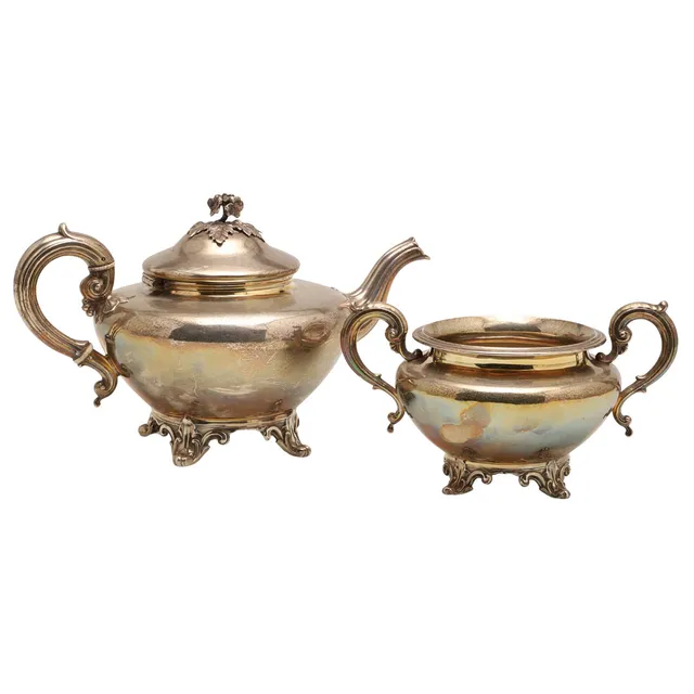 A VICTORIAN SILVER TEAPOT AND SUGAR BASIN.