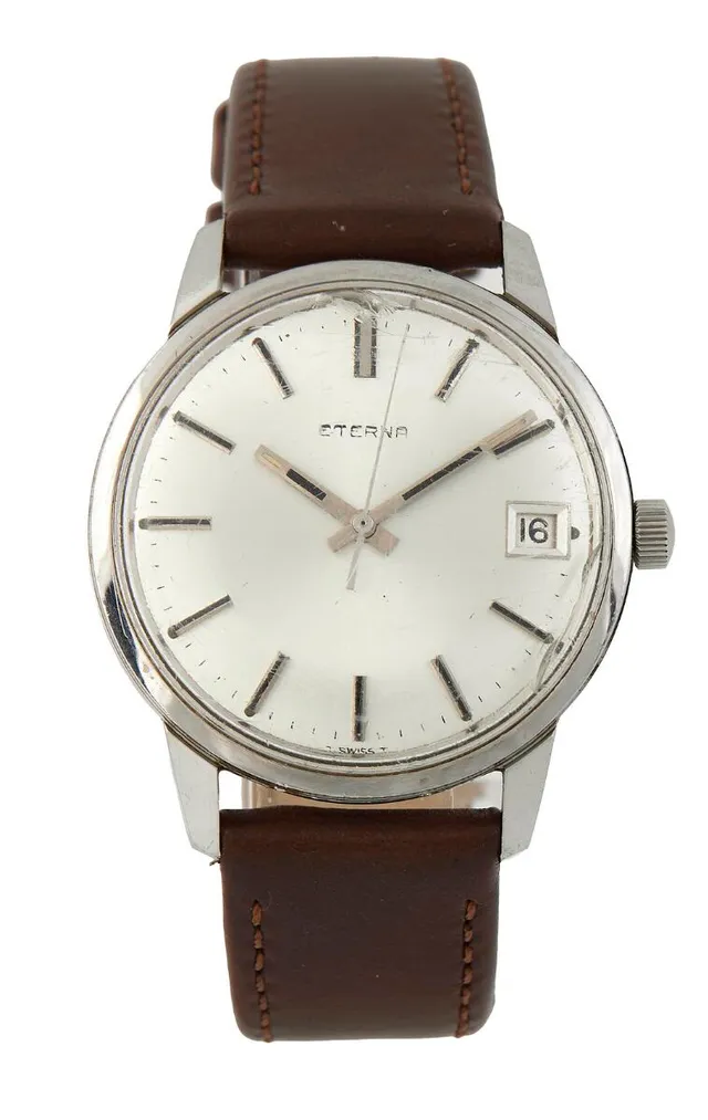 Steel, ref. 140T. Mechanical movement with manual winding and date indication, cal. 1486K. Brown calf leather strap with C-buckle of doublé. Ø 35 mm. 1960s.