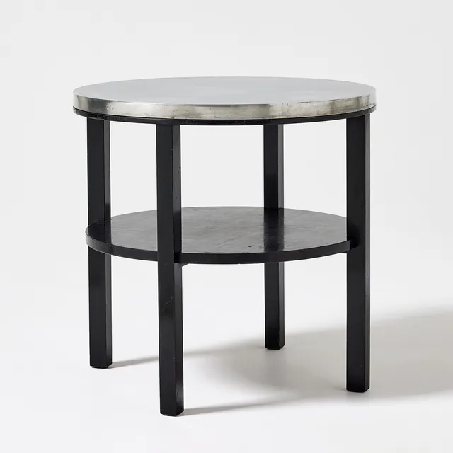 FIRMA SVENSKT TENN. Table, Stockholm 1932, model B 353, top in pewter, leg stand in black lacquered birch.