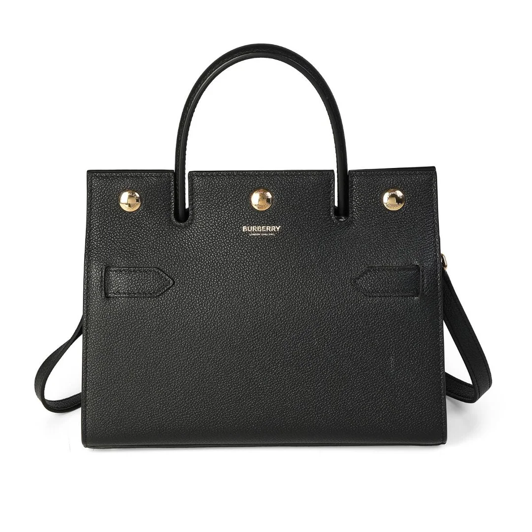 “Mini Title Bag” of black leather with gold-tone hardware, detachable shoulder strap, short handle, two compartments with an interior pocket and beige lining. H. 20 x W. 24 x D. 10 cm. — Designer Handbags & Fashion — Bruun Rasmussen