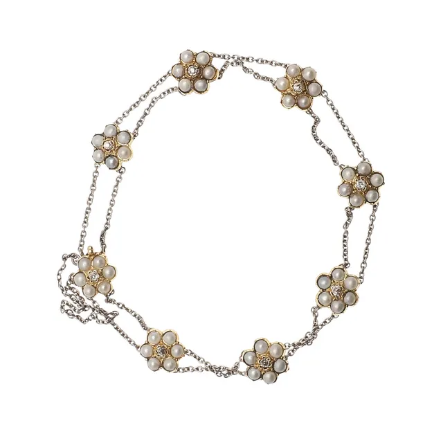 AN EARLY TWENTIETH CENTURY PEARL AND DIAMOND CLUSTER BRACELET.