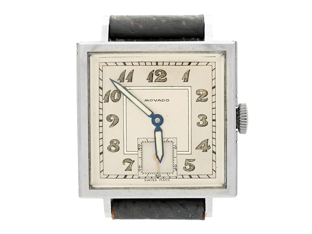 MOVADO, herrur, 27 x 26 (34,5) mm, "Francois Borgel Case", Cal 470, Boett nr. 480272 / 14724, stål, manuell, plexiglas, liten sekundvisare, relumade visare, skadad urtavla, läderband, ca 1945, etui (K.A.Tellander, Vamdisplan 1 Sthlm). — Klockor/Movado — Kaplans
