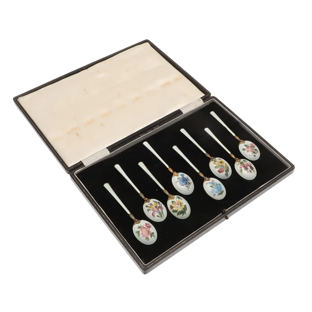 A CASED SET OF EIGHT 20TH CENTURY SILVER GILT AND ENAMEL COFFEE SPOONS. — Silver — Lawrences Auctioneers