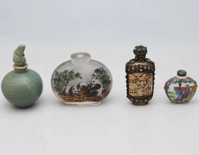 Chinese celadon porcelain bottle and three Chinese glass, metal and bone and porcelain cigar-jars, mid 20th Century.