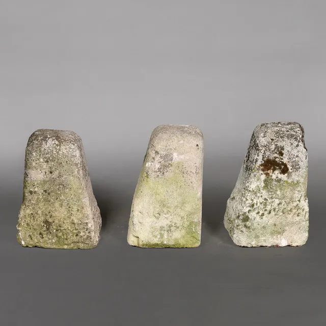 A SET OF THREE EARLY TO MID 19TH CENTURY LIMESTONE BOLLARDS.