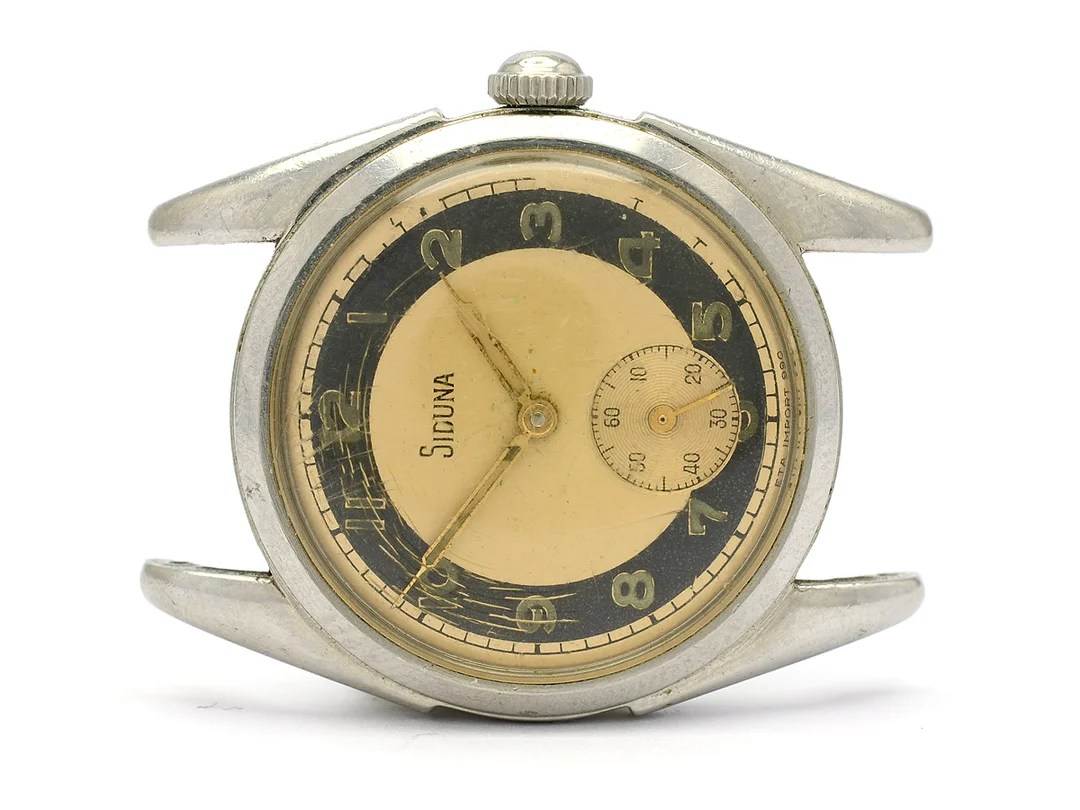 SIDUNA, herrur, 32 mm, Cal 990, Boett nr. 1/267904, stål, manuell, plexiglas (skadat), liten sekundvisare, skadad urtavla, ca 1955. — Klockor/Siduna — Kaplans