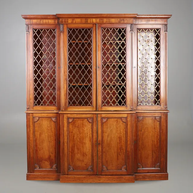 AN EDWARDIAN MAHOGANY BREAKFRONT BOOKCASE.