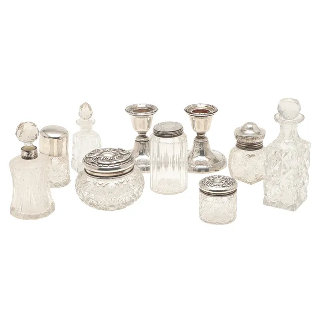 A COLLECTION OF CUT GLASS SCENT BOTTLES AND JARS, SOME SILVER TOPPED ETC.