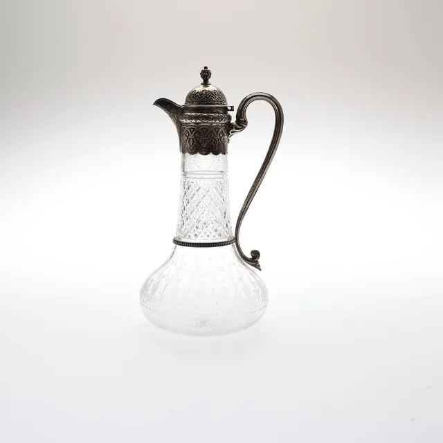 VICTORIAN SILVER MOUNTED CUT AND ENGRAVED GLASS CLARET JUG.