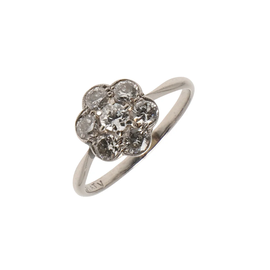 AN EARLY 20TH CENTURY PLATINUM AND DIAMOND CLUSTER RING. — Rings — Lawrences Auctioneers