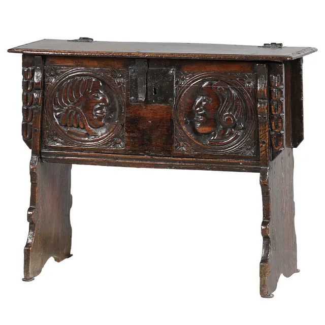 AN ANTIQUE OAK CARVED COFFER OF SMALL PROPORTIONS.