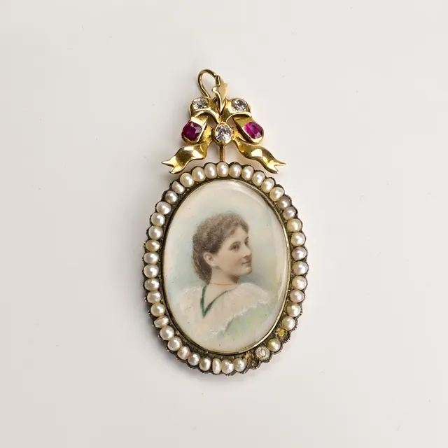 A VICTORIAN YELLOW METAL, SEED PEARL, DIAMOND AND RUBY MOUNTED PORTRAIT PENDANT.