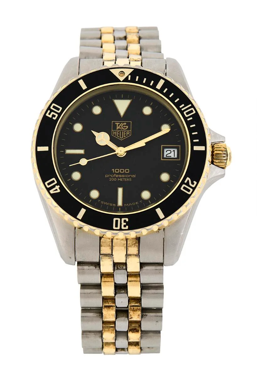 1000 Professional of steel and 18k gold, ref. 980.020N. Quartz movement with date indication, cal. TH 389. TAG Heuer bracelet of steel and gold cap with folding clasp. Circumference approximately 17 cm. Ø 38 mm. 1985–1992. — Clocks & watches/Wristwatches — Bruun Rasmussen
