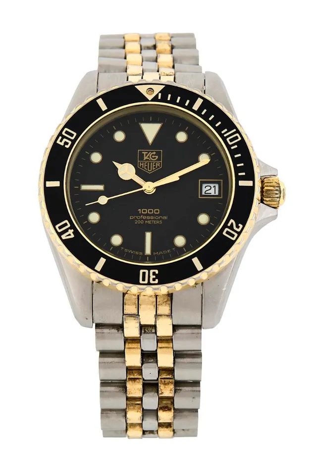 1000 Professional of steel and 18k gold, ref. 980.020N. Quartz movement with date indication, cal. TH 389. TAG Heuer bracelet of steel and gold cap with folding clasp. Circumference approximately 17 cm. Ø 38 mm. 1985–1992.