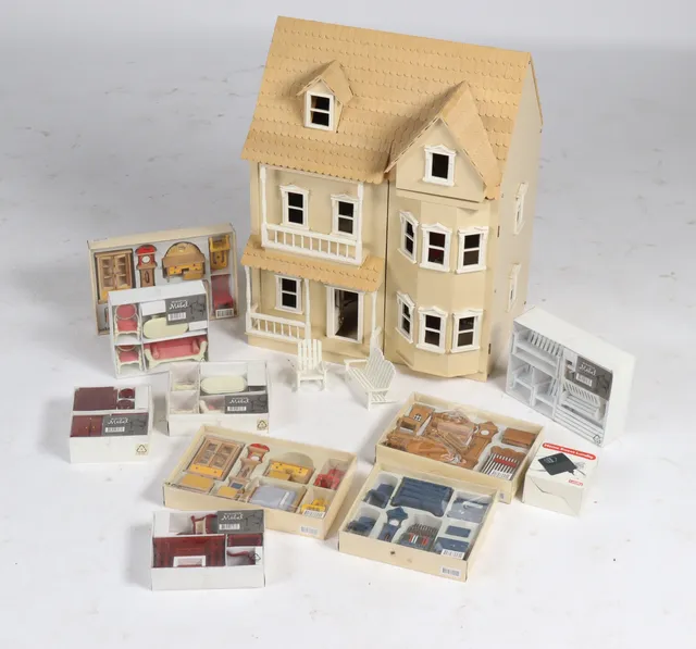 Large dollhouse made of wood and plastic and various dollhouse furniture