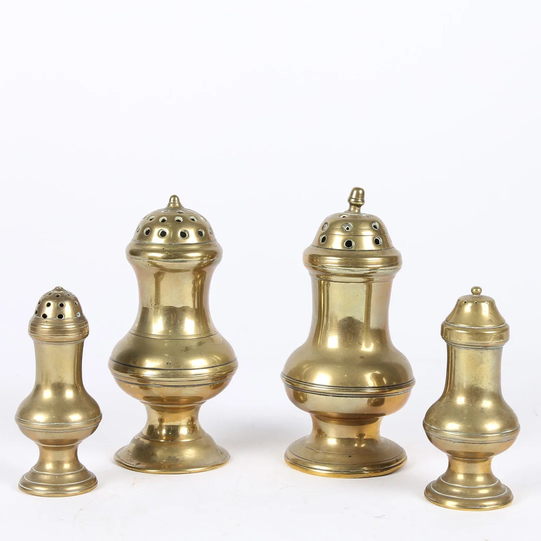A GROUP OF FOUR GEORGE III BRASS CASTERS OR PEPPERETTES, CIRCA 1770-1800. — Pewter, Brass & Copper — Bishop & Miller
