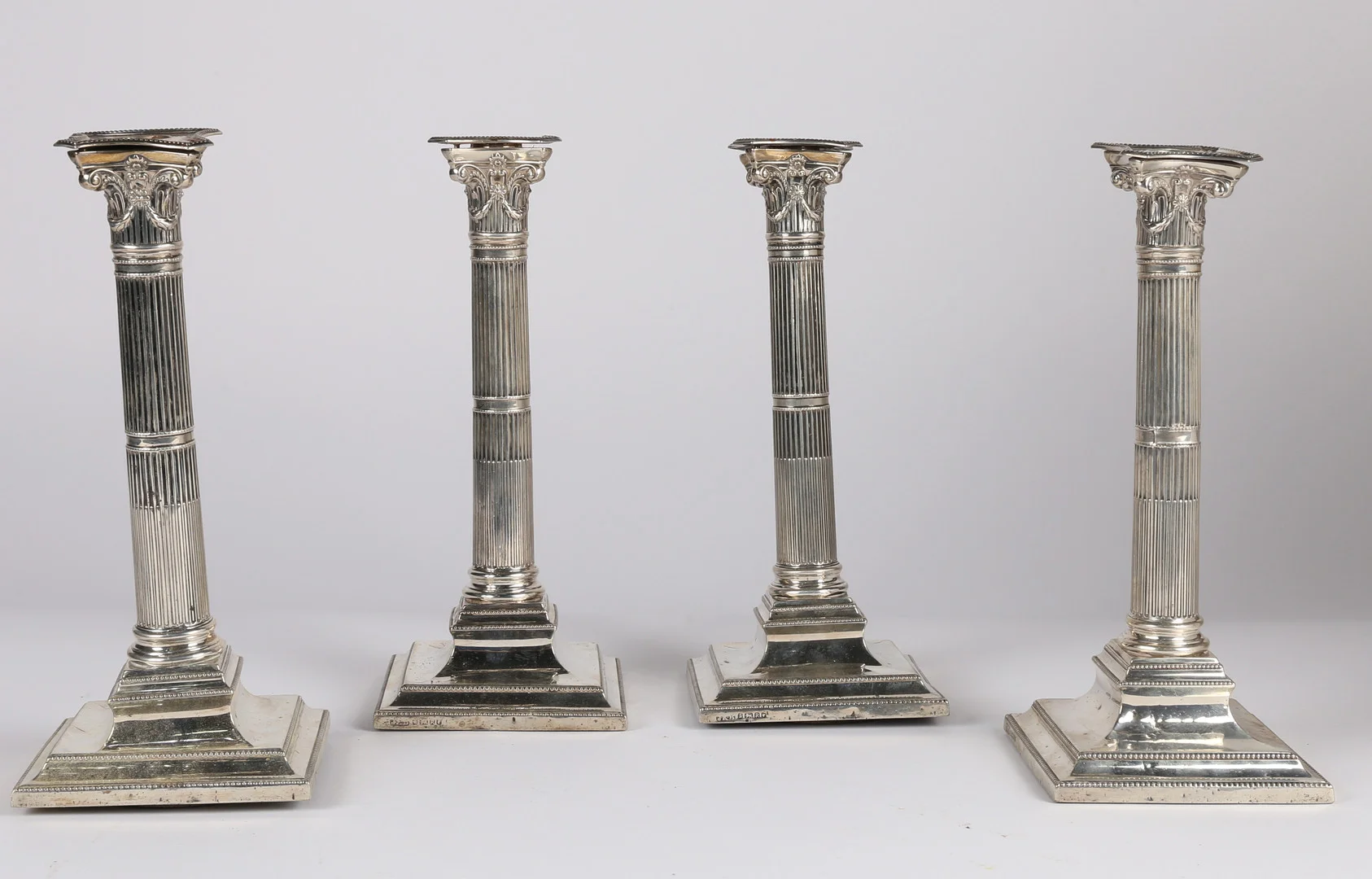 A SET OF FOUR VICTORIAN SILVER CANDLESTICKS (4). — Silver — Bishop & Miller
