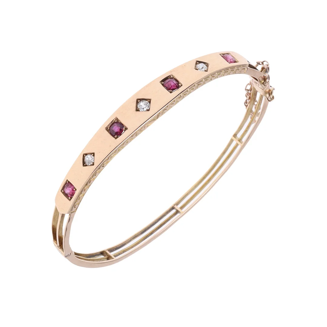 A 15CT GOLD, RUBY AND DIAMOND HALF HINGED BANGLE. — Bracelets — Lawrences Auctioneers