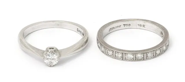 An eternity and solitaire diamond ring each set with brilliant-cut diamonds, mounted in respectively 18k and 14k white gold. Weight in total app. 7 g. Size 57.5 and 58. (2)