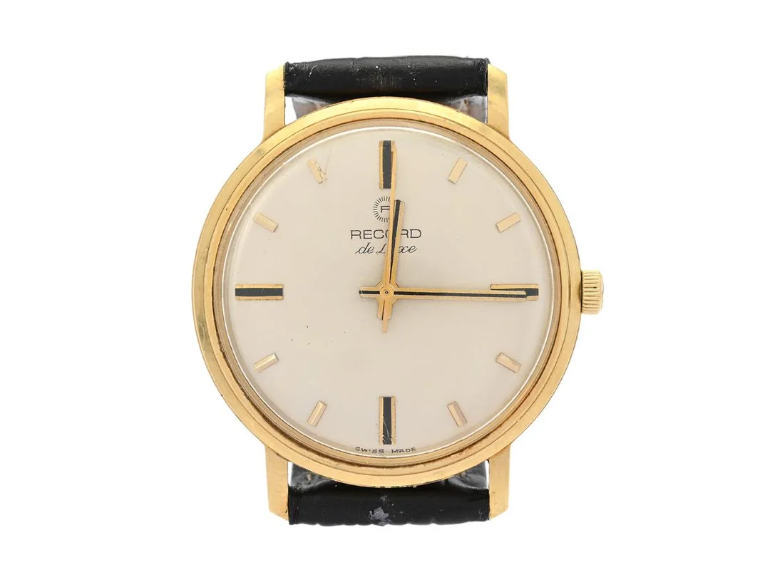 RECORD, De Luxe, Cal 650, Boett nr. 112006L / 37, herrur, 34 mm, 18K guld, manuell, plexiglas, läderband, ca 1970. — Klockor/Record — Kaplans
