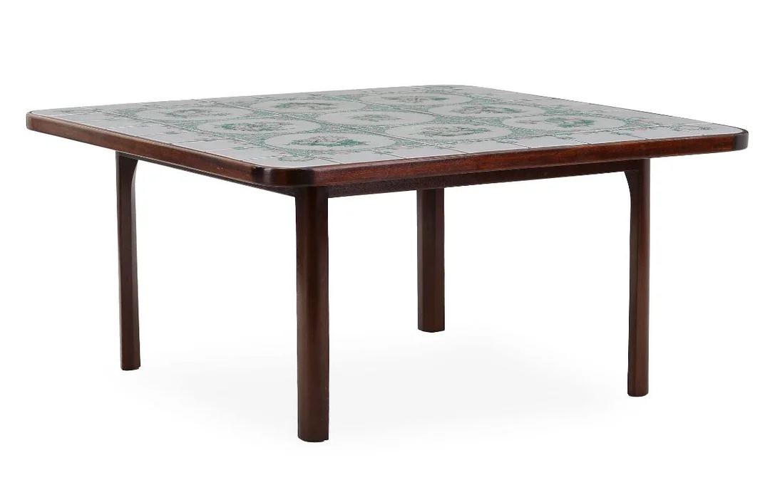 Square coffee table with mahogany frame. Top with tiles in green, light and pink shades. Sign. Bjørn Wiinblad april 1976. H. 49.5. L./W. 101.5. — Modern Furniture — Bruun Rasmussen