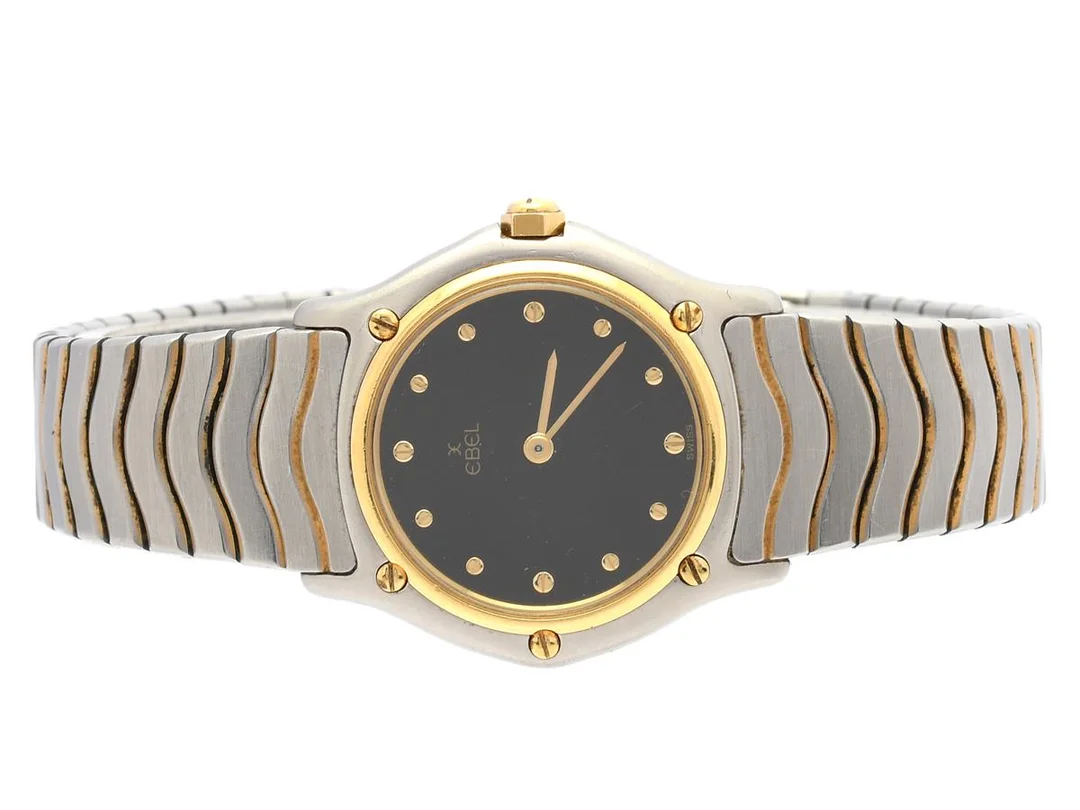 EBEL, Classic Wave, Serie nr. 12601667, Boett nr. 181908, damur, 26,5 mm, stål/guld, quartz, safirglas (repor), skadad urtavla, integrerad originallänk, viklås, ca 1990. — Klockor/Ebel — Kaplans