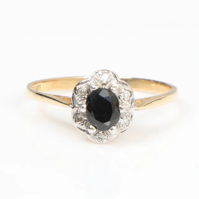 A 9 CARAT GOLD SAPPHIRE AND DIAMOND SET RING.