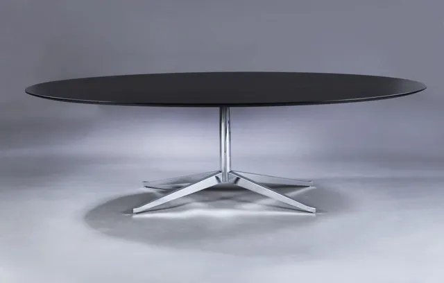 Florence Knoll. Dining/conference table, oval top in black-glazed wood