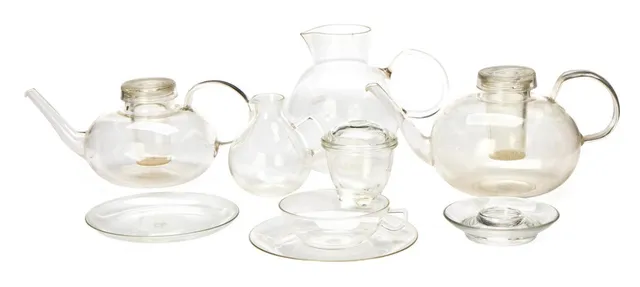 Bauhaus glass tea service. Designed primarily in the 1930s. Produced by and marked Jenaer Glas, partly marked Schott & Gen. and Saale Glas. East and West Germany. Also six unmarked pressed-glass egg cups. (76)