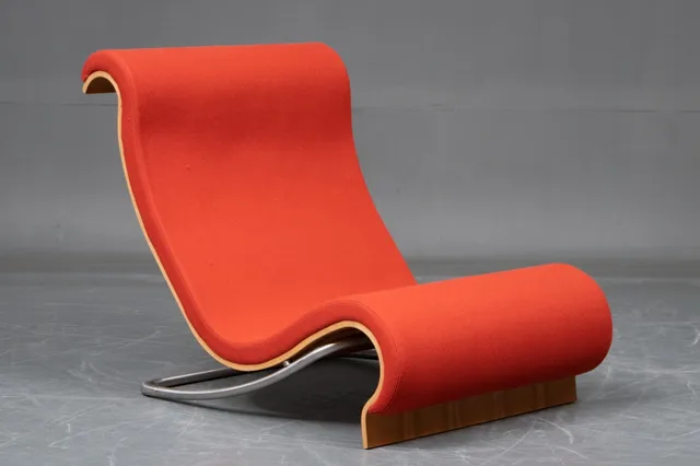 Jørn Utzon. 'Aurora', high-backed lounge chair in walnut, upholstered in rust-red wool