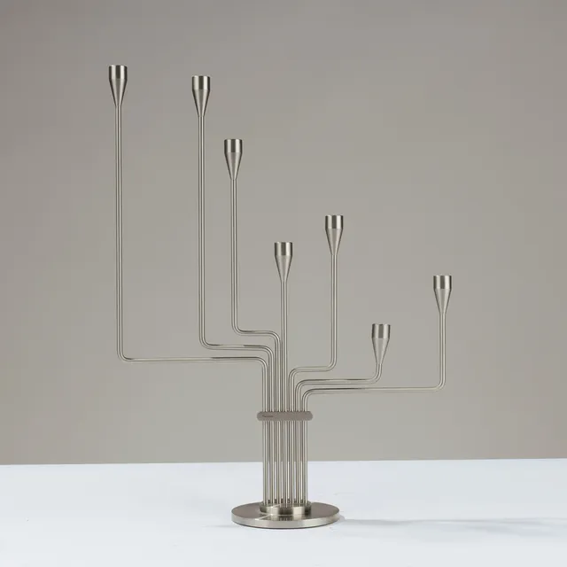 PIET HEIN. Candlestick in stainless steel with seven rotatable arms, model "Karlsvognen", designed in 1944, Denmark.
