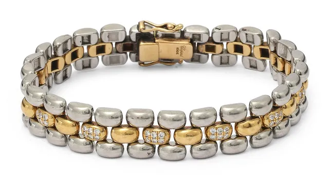 A bracelet set with numerous brilliant-cut diamonds, mounted in 18k gold and steel. Weight app. 33 g. W. 10 mm. L. 17 cm. Serial no. 9628856.