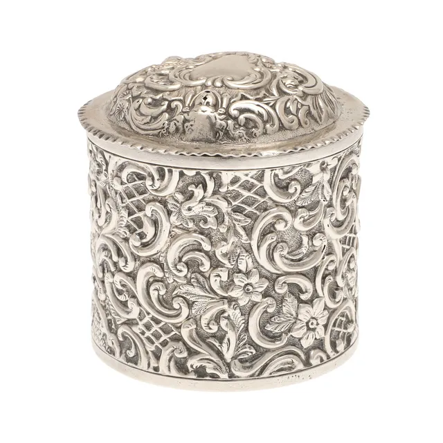AN EMBOSSED SILVER CANNISTER.