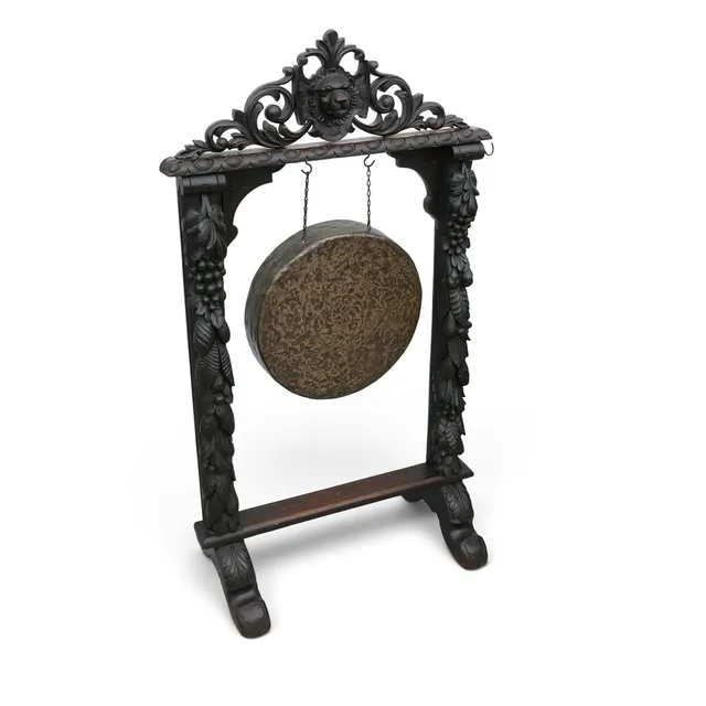 A VICTORIAN CARVED OAK HALLWAY GONG.