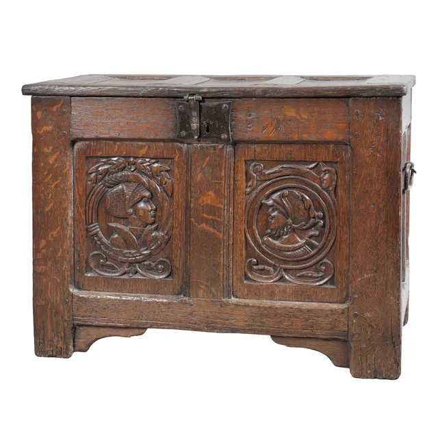 A 16TH CENTURY CARVED OAK COFFER WITH ROMAYNE PANELS.