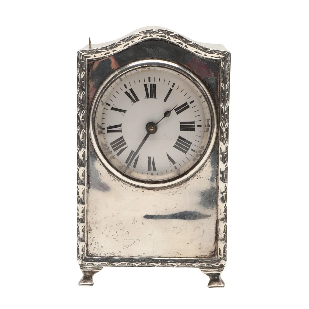 A SILVER CASED MANTEL TIMEPIECE. — Silver — Lawrences Auctioneers