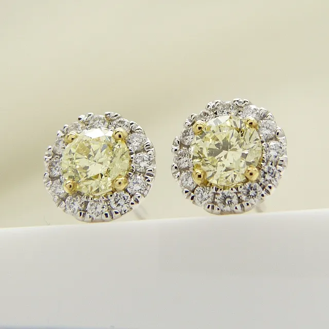 FANCY YELLOW DIAMOND STUDS, 0.82 carats.