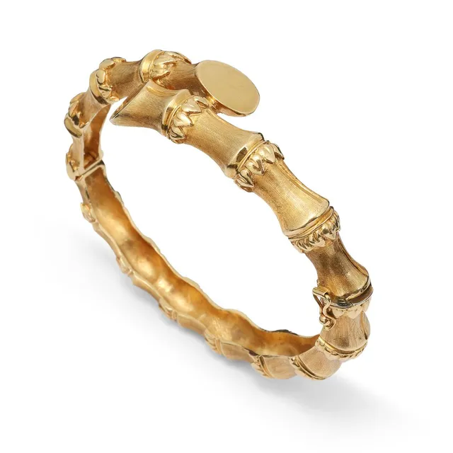 An openable bangle of 18k gold with partly satin finish. Weight app. 40 g. W. 7–15 mm. Inner diam. 5×6 cm.