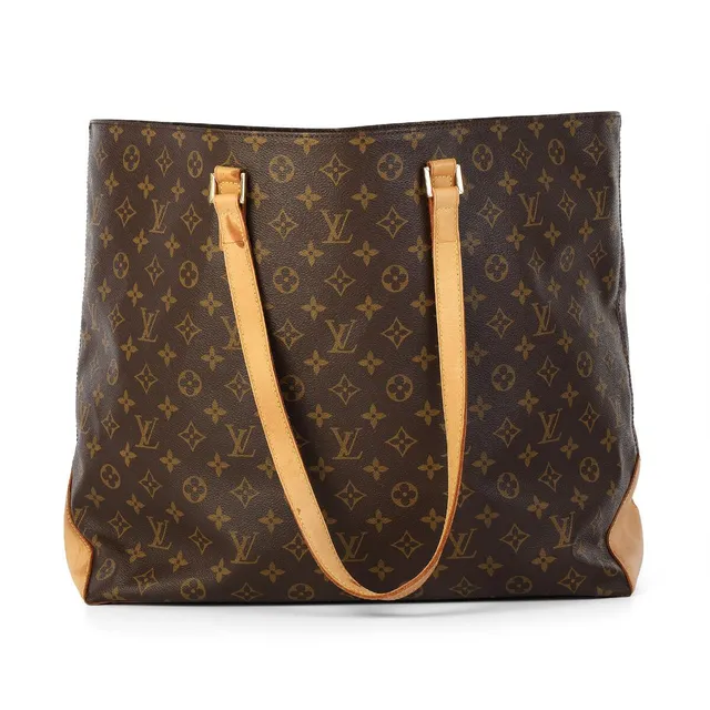 A “Cabas Alto” bag of brown monogram canvas with brown leather trimmings, gold tone hardware, two handles, an open compartment with two interior pockets, one of which has a zip fastening, and brown fabric lining. H. 35 × W. 40 × D. 15 cm. 2000.