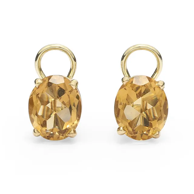 A pair of citrine ear clips each set with an oval-cut citrine mounted in 14k gold. Weight app. 7 g. W. 9 mm. L. 11 mm. (2)
