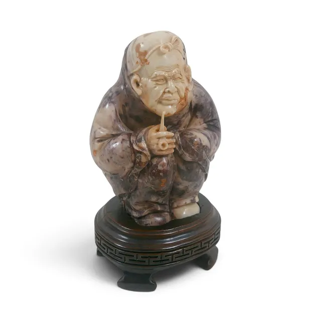 AN ORIENTAL SOAPSTONE FIGURE.