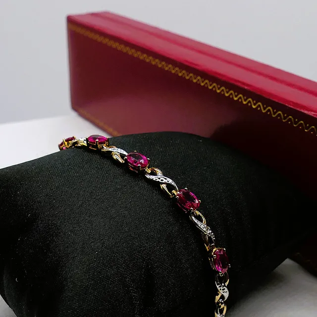 YELLOW GOLD BRACELET SET WITH CREATED OVAL RUBIES AND DIAMONDS.
