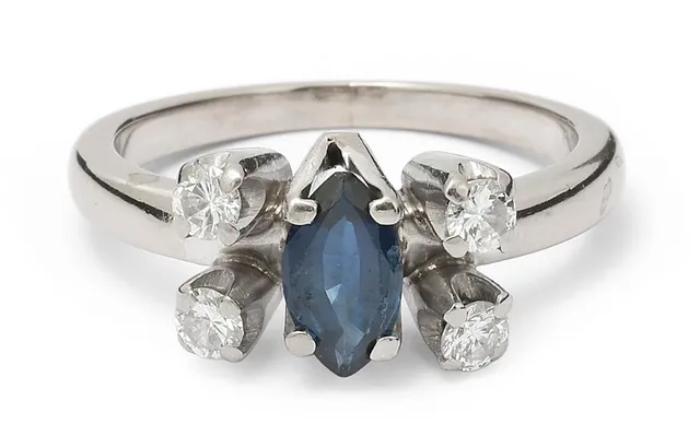 A sapphire and diamond ring set with a marquise-cut sapphire and brilliant-cut diamonds mounted in 14k white gold. Weight app. 5 g. W. 8 mm. Size 52.5.