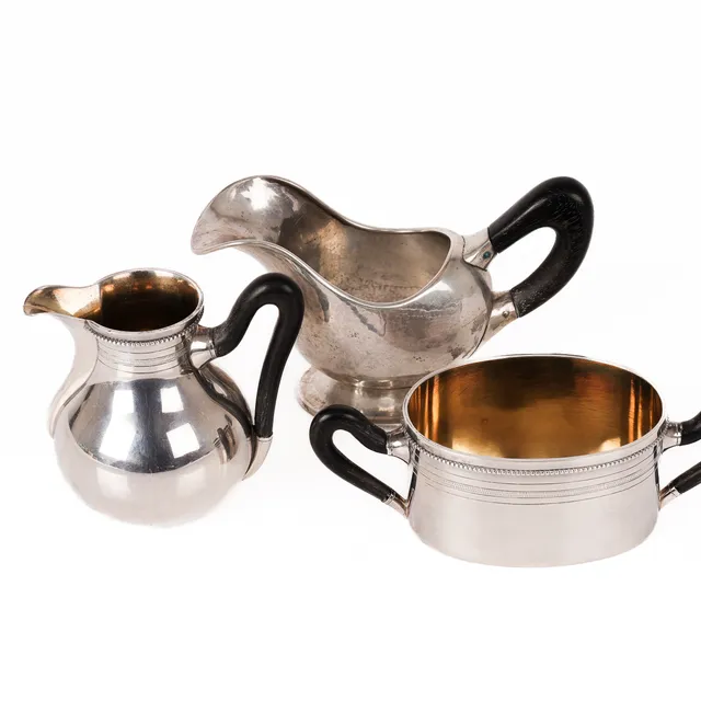 P. Hertz: Small jug and sugar bowl of sterling silver, as well as a beautifully crafted creamer of silver. (3)