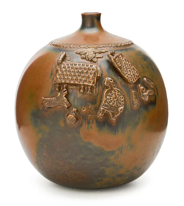 Stoneware vase modelled with animals and figures in relief. Decorated with brown glaze with green elements. Signed Stig L. and with studio hand. Made by Gustavsberg. H. 24 cm. Diam. 20 cm.