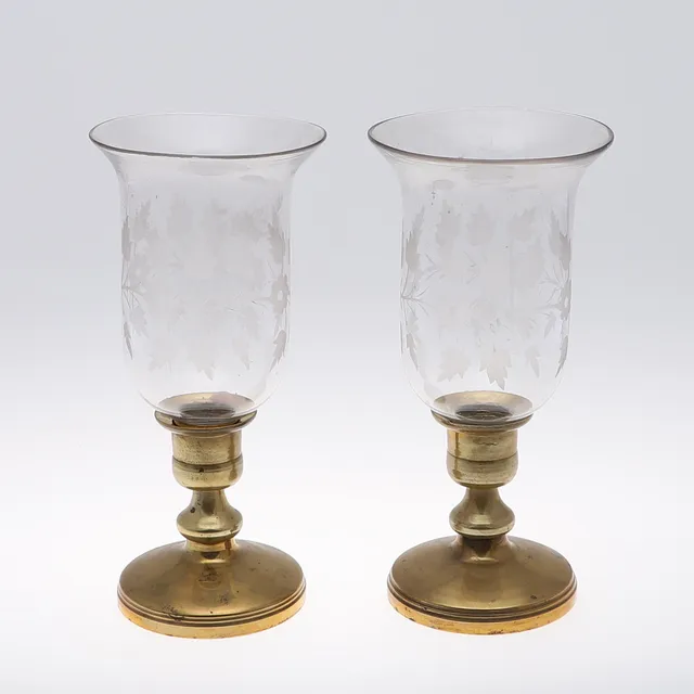A PAIR OF BRASS CANDLEHOLDERS.