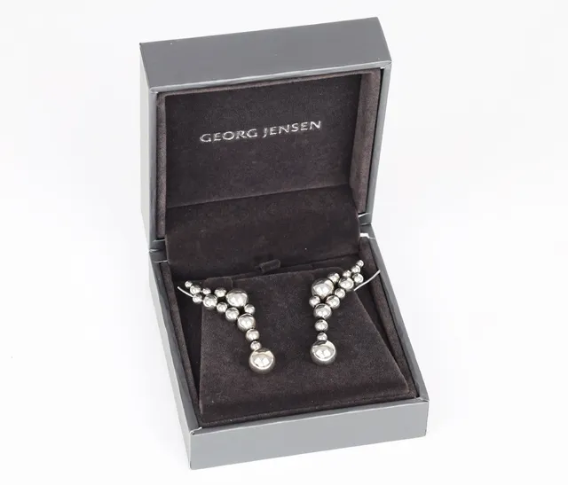 Georg Jensen: A pair of 'Moonlight Grapes' ear cuffs of sterling silver. (2)
