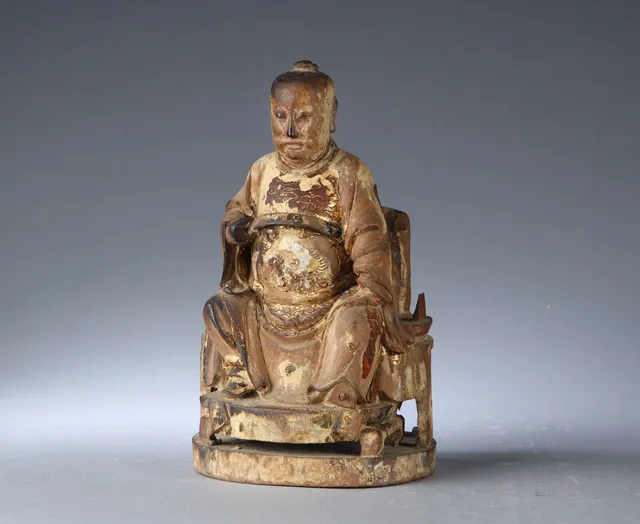 Chinese figure of an official carved from wood, 19th century